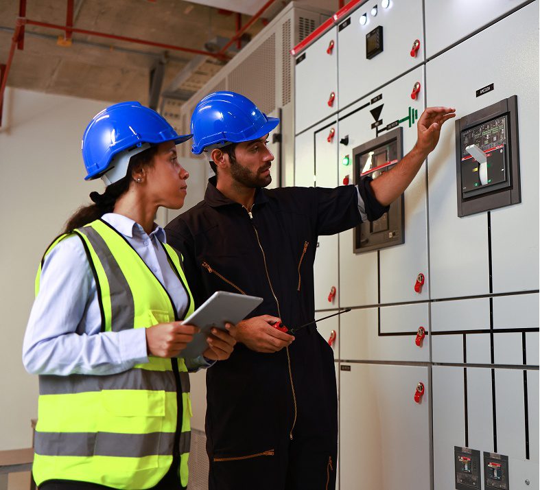 Two engineers discuss control panel operation.