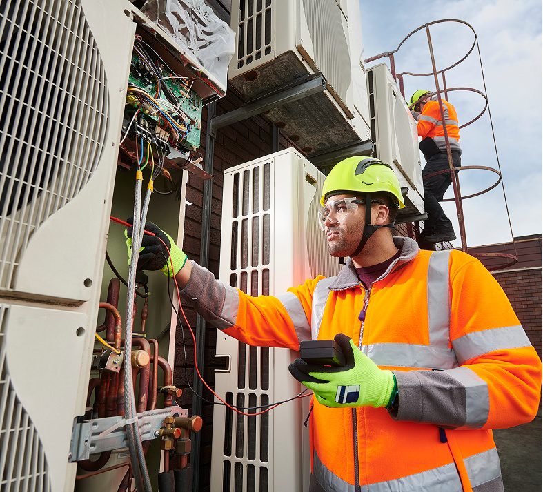 Technicians working on outdoor electrical equipment.